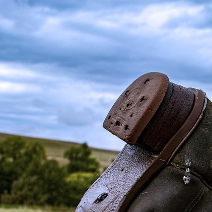 western boots dancing on a hardwood floor