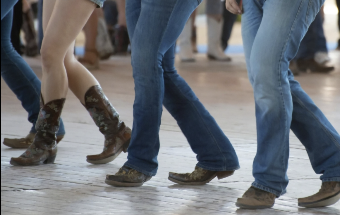 western boots dancing on hardwood floor